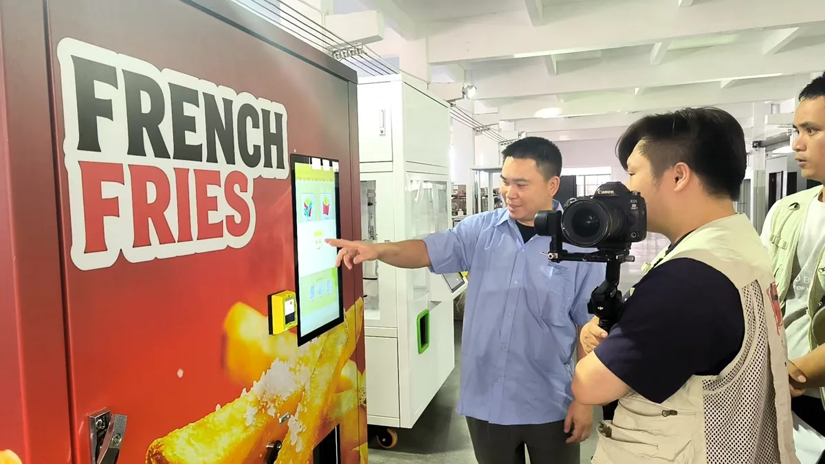 Before You Buy a Smoothie Machine, Take a Look Inside This 27-Year-Old Jiangmen Factory 2 Hommy staff demo fries vending machine touchscreen, Today Lingnan shoot